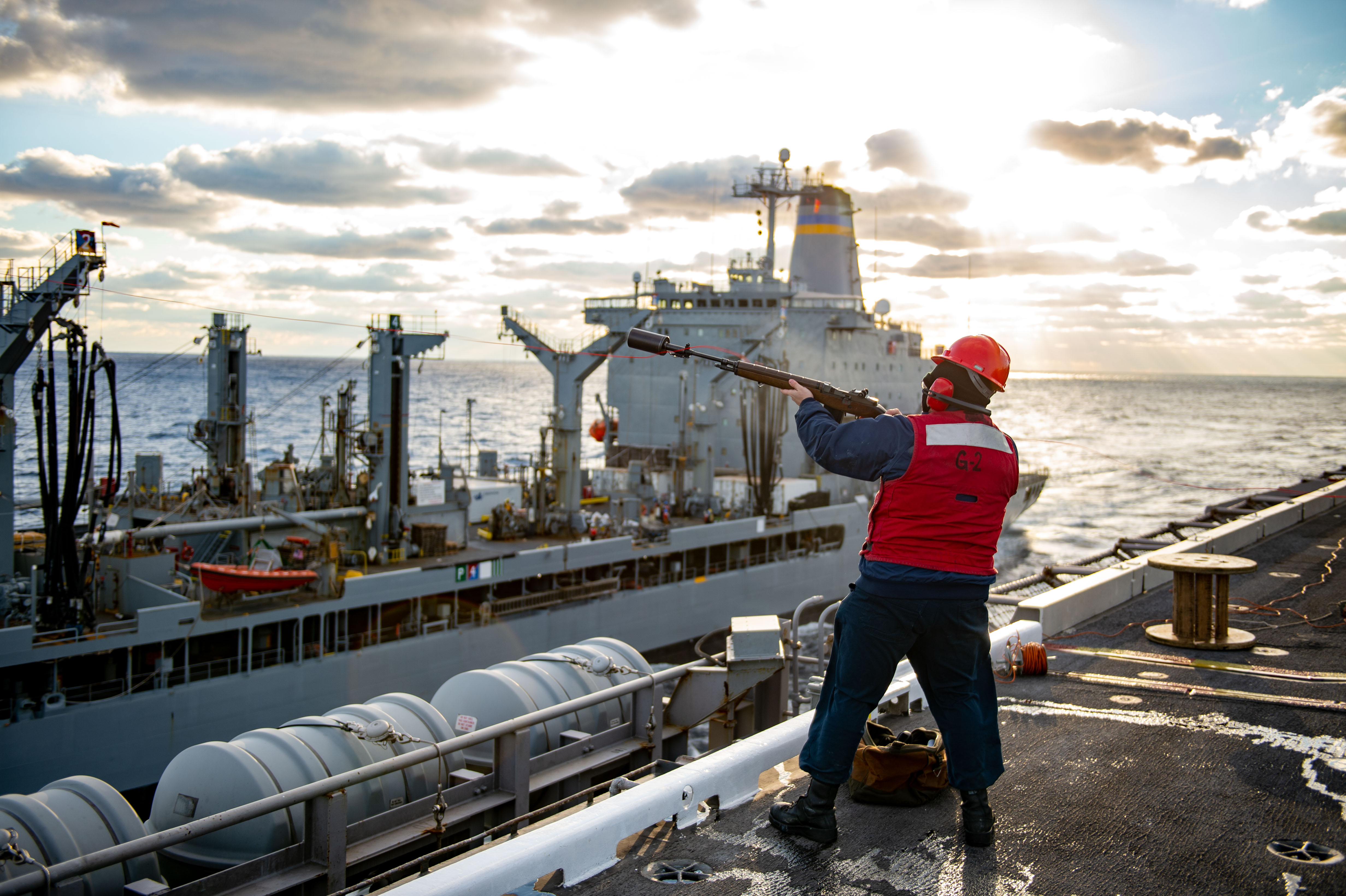Gunner's Mate 3rd Class Mitchell Granger, from Jacksonville, Fla., shoots a phone-and-distance line to the fleet replenishment oiler USNS John Lenthall (T-AO 189) during a fueling-at-sea aboard the Nimitz-class aircraft carrier USS Dwight D. Eisenhower (CVN 69).