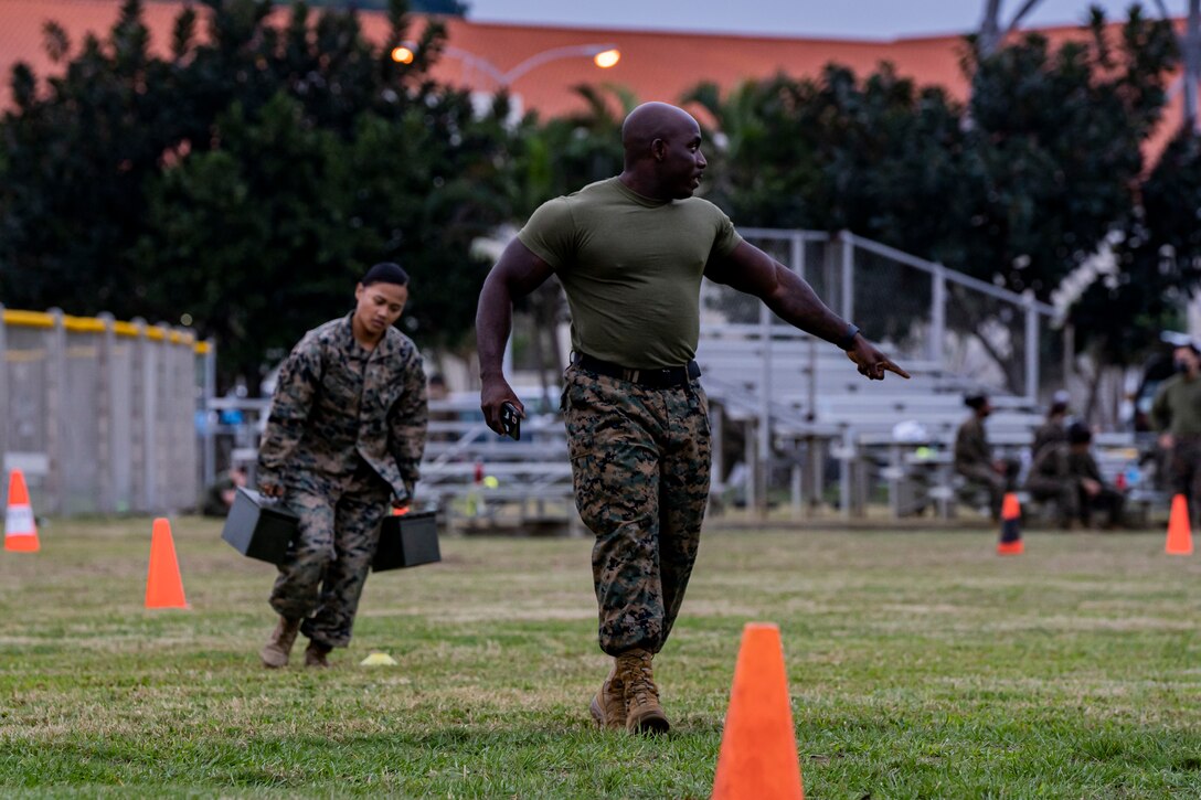 U.S. Marine Corps Gunnery Sgt. Christian Hutson, the battalion operations chief with Headquarters and Support Battalion, instructs a Marine through the combat fitness test on Camp Foster, Okinawa, Japan, Nov. 25, 2020. Hutson is a native of Bedford-Iverson, Brooklyn, New York. (U.S. Marine Corps photo by Cpl. Brennan J. Beauton)