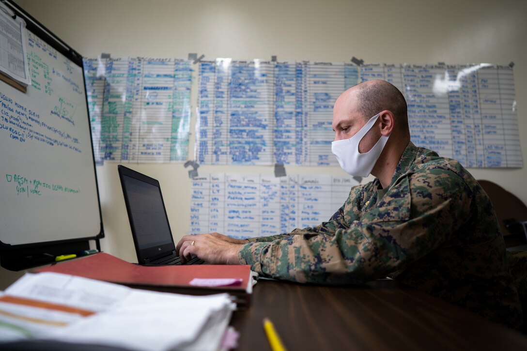.S. Marine Corps Maj. Gregory Procaccini, the Joint COVID-19 Response Center Liaison Element officer in-charge with the COVID Cell, drafts an email at the Public Health & Behavioral Health center, Camp Foster, Okinawa, Japan Dec. 2, 2020.