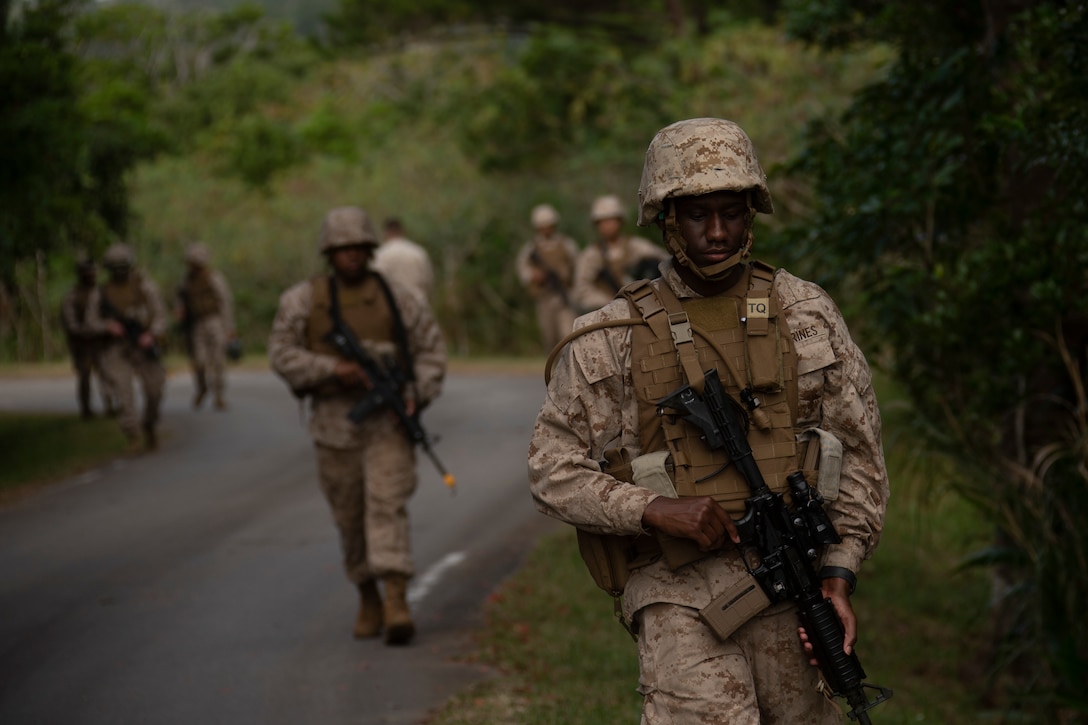 U.S. Marines with Marine Corps Installations Pacific conduct an administrative movement during Training Exercise Frost at Camp Hansen, Okinawa, Japan, Nov. 19, 2020. Training Exercise Frost consisted of patrol exercises, room clearing training and infantry tactical skills to reinforce basic Marine Corps tactics to Marines that serve as the supporting establishment in base operations.. (U.S. Marine Corps photo by Lance Cpl. Alex Fairchild)