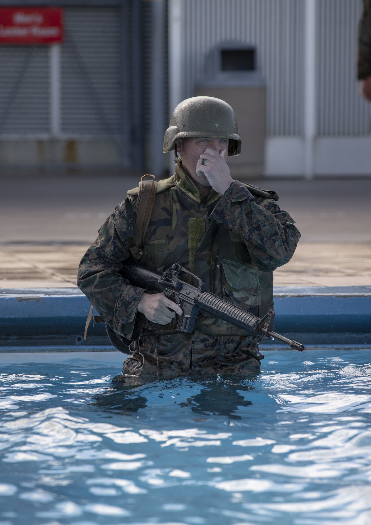 U.S. Marine Corps Sgt. Maj. Thomas Tabisz, the sergeant major for Headquarters and Support Battalion, Marine Corps Installations Pacific, prepares for a gear shed during Water Survival Intermediate at the Foster Aquatic Center on Camp Foster, Okinawa, Japan, Nov. 20, 2020. All Marines are required to complete the Water Survival Basic swim qualification every two years and have a follow-on opportunity to attempt the advanced WSI course. (U.S. Marine Corps photo by Lance Cpl. Zachary Larsen)