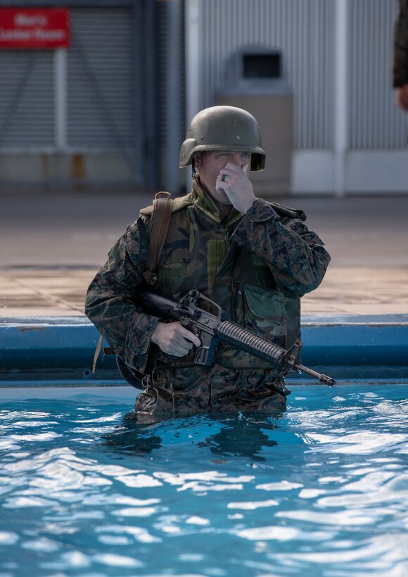 .S. Marine Corps Sgt. Maj. Thomas Tabisz, the sergeant major for Headquarters and Support Battalion, Marine Corps Installations Pacific, prepares for a gear shed during Water Survival Intermediate at the Foster Aquatic Center on Camp Foster, Okinawa, Japan, Nov. 20, 2020.