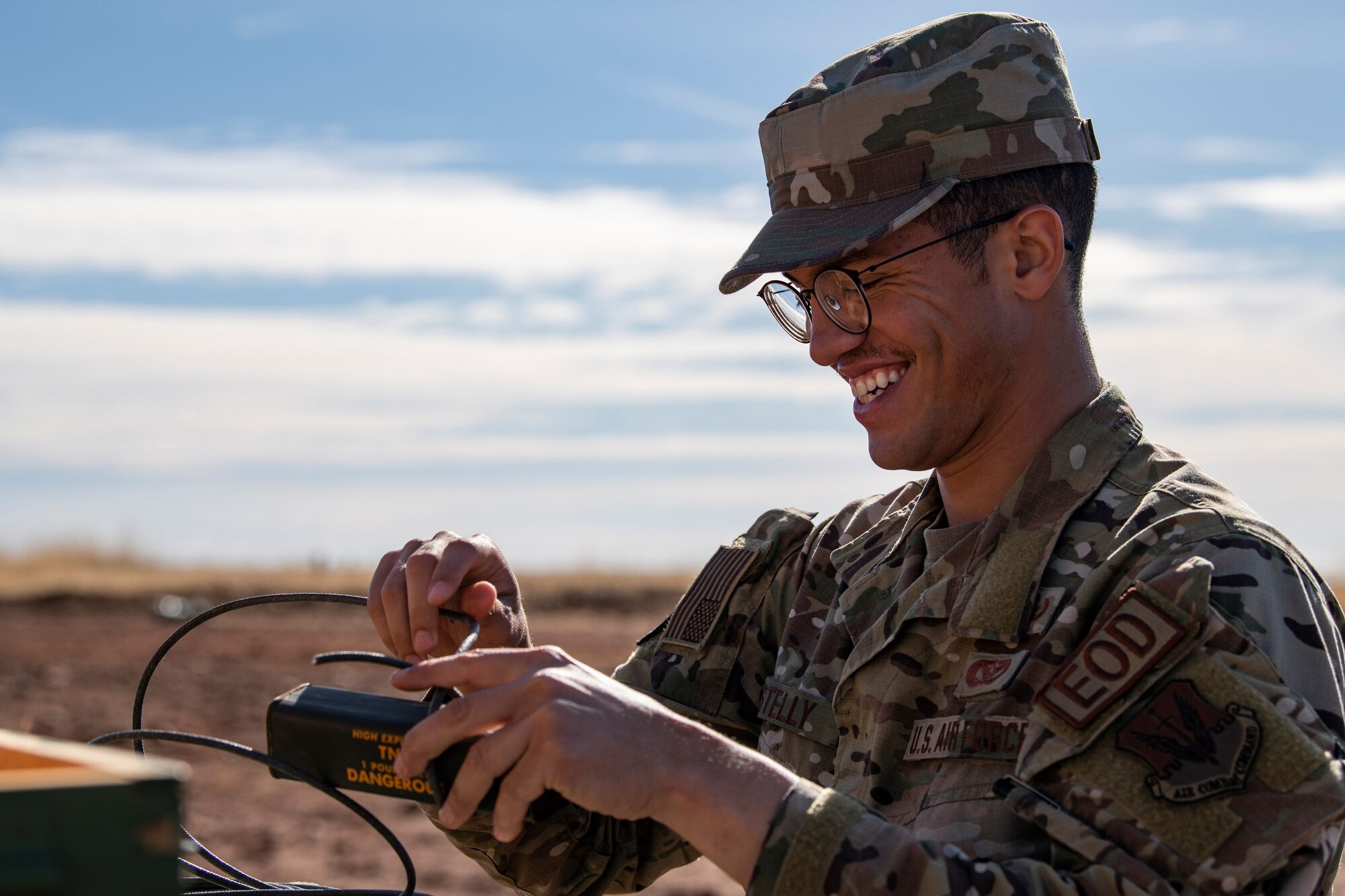 Airman 1st Class Donnovan Stelly, 9th Civil Engineering Squadron Explosive Ordnance Disposal team member, wraps detonating cord around some TNT during military working dog detection training on Beale Air Force Base.