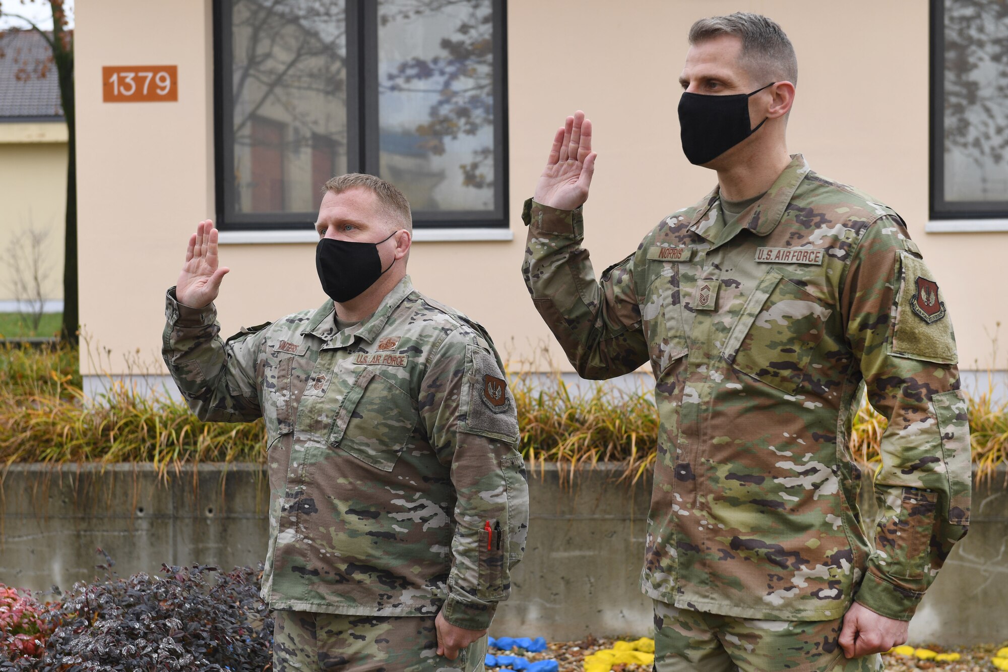 Senior Master Sgt. Sean Winters, 606th Air Control Squadron cyber operations and maintenance superintendent, left, and Senior Master Sgt. Paul Norris, 606th ACS cyber operations and maintenance operations superintendent, right, are sworn into the U.S. Space Force at Aviano Air Base Italy, Dec. 3, 2020. Winters and Norris were the first Airmen to enlist into the U.S. Space Force while stationed at Aviano.