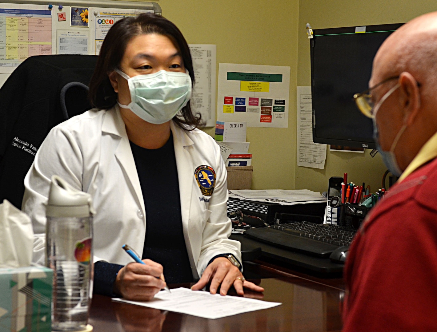 Alexandra Vance, Naval Hospital Jacksonville�s clinical pharmacy coordinator, conducts a medication review with a patient.