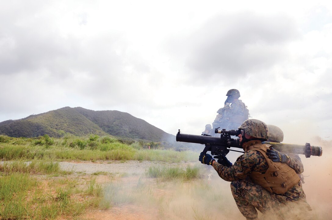 Lance Cpl. Derek W. Schultz, combat engineer, Marine Wing Support Squadron 172, Marine Wing Support Group 17, 1st Marine Aircraft Wing, III Marine Expeditionary Force, fires a shoulder-launched multipurpose assault weapon at Camp Schwab July 20. Schultz spent the week at the range training on the M249 squad automatic weapon, M240B medium machine gun, M2 .50-caliber Browning machine gun and the MK19 grenade launcher.
