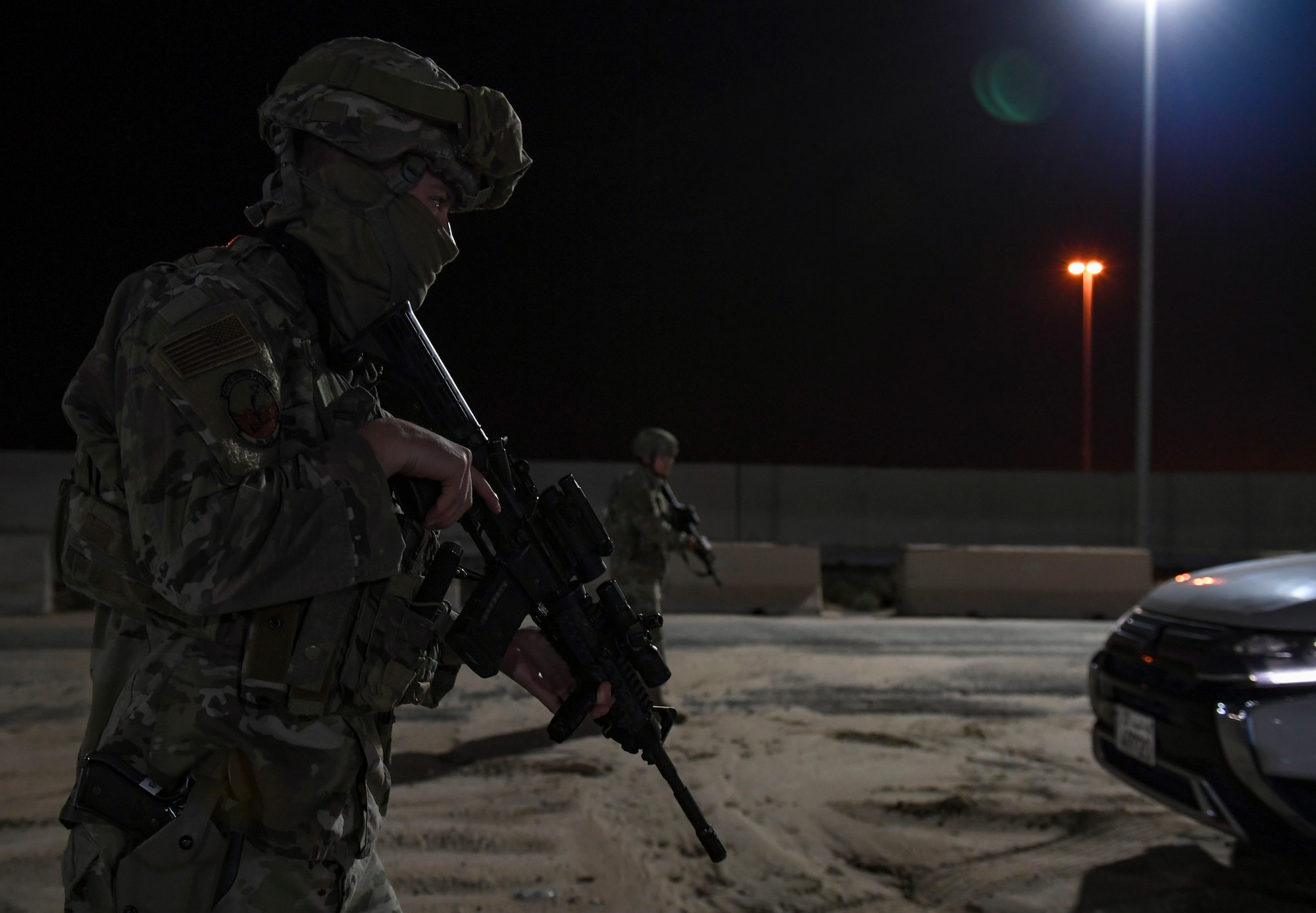 U.S. Air Force Senior Airmen Samuel Turley and Alberto Trinidad Marquez, 386th Expeditionary Security Forces Squadron response force leaders, approach a suspicious vehicle during the Marauder 21-02 exercise at Ali Al Salem Air Base, Kuwait, Dec. 8, 2020. The exercise aimed to test units’ response to elevated Force Protection Condition levels in shifting scenarios. (U.S. Air Force photo by Senior Airman Monica Roybal)