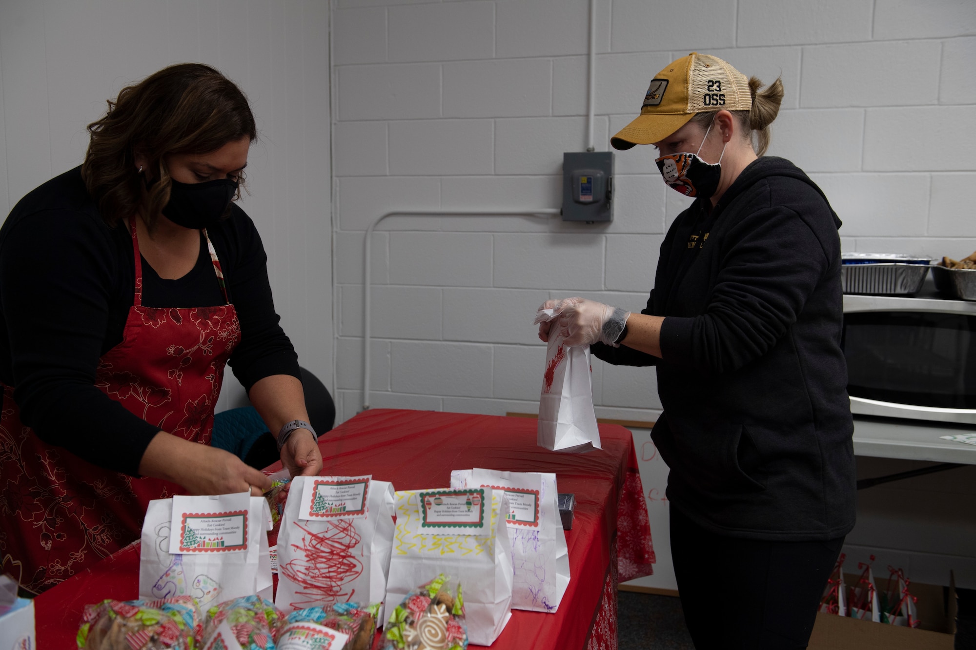 A photo of volunteers bagging cookies.
