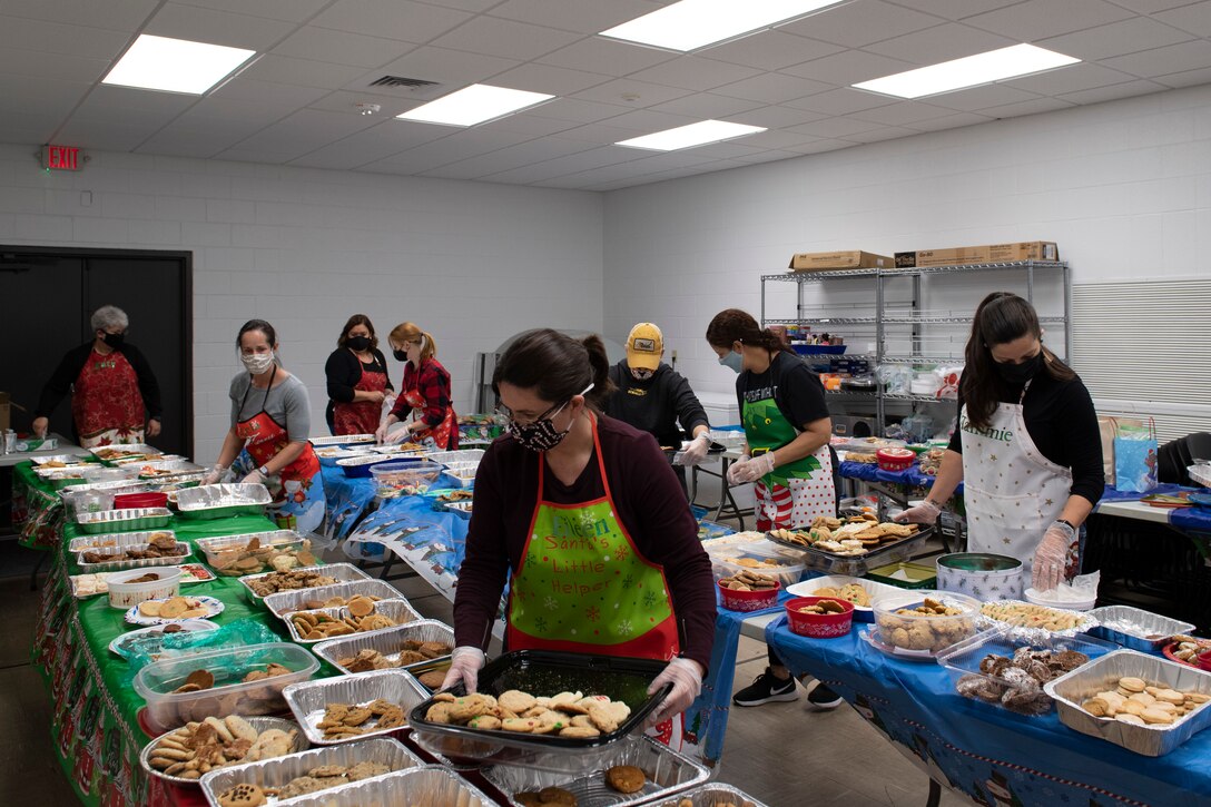A photo of volunteers preparing cookie trays.