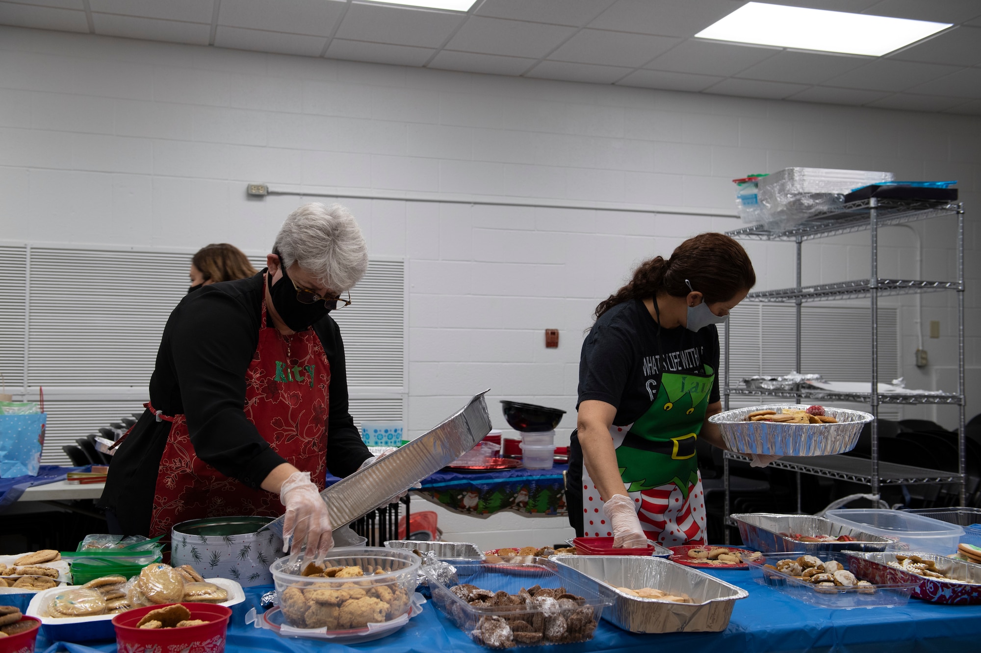 A photo of volunteers preparing cookie trays.