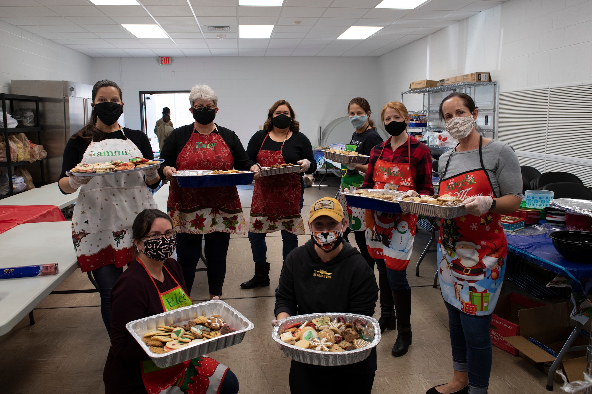 A photo of volunteers holding cookies.