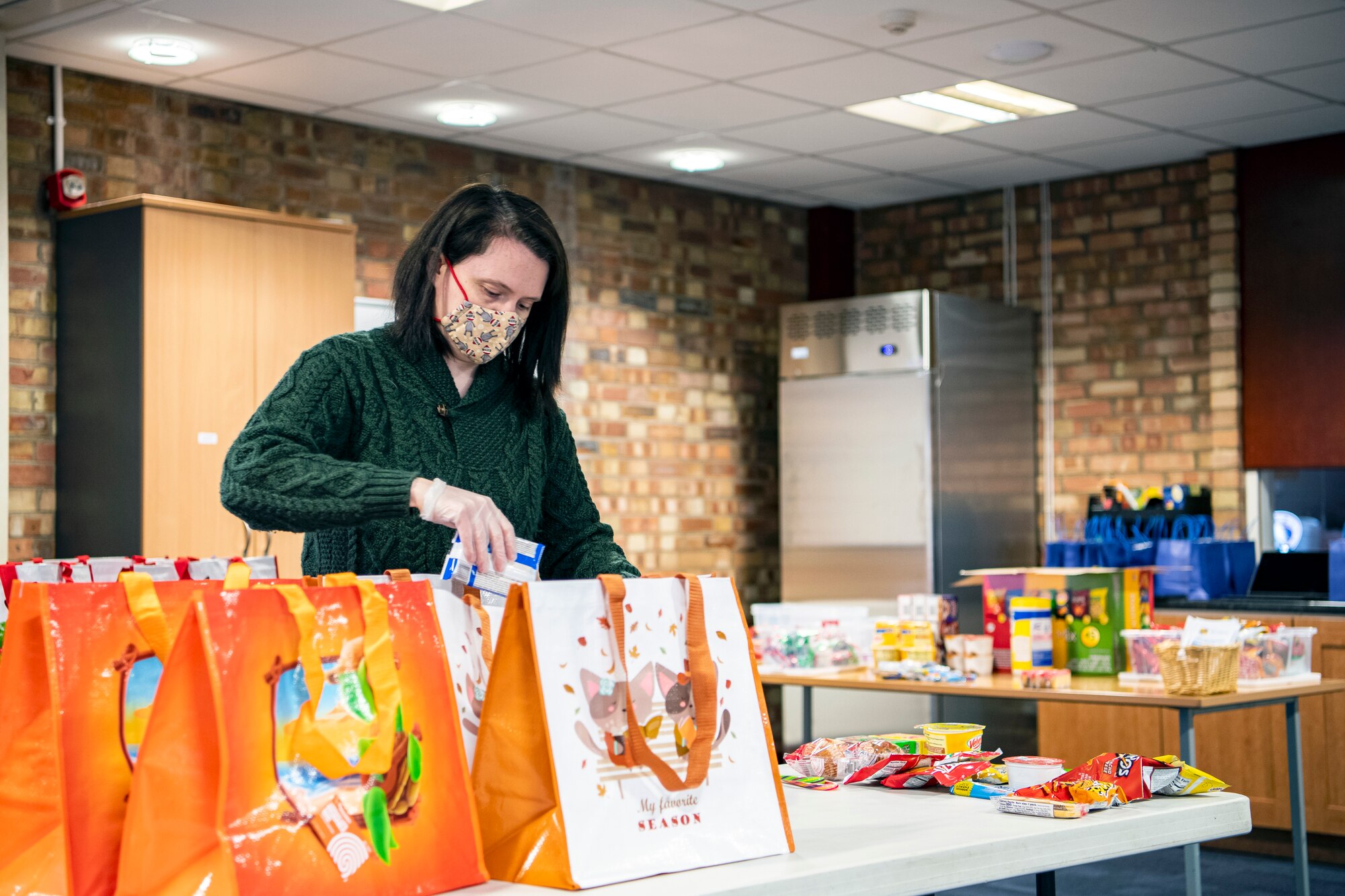 Megan Cwiakala, RAF Alconbury Chapel religious education coordinator, prepares care packages at RAF Alconbury, England, Dec. 7, 2020. The RAF Alconbury chaplain team has been providing care packages for Airmen and families currently in quarantine. (U.S. Air Force photo by Senior Airman Eugene Oliver)