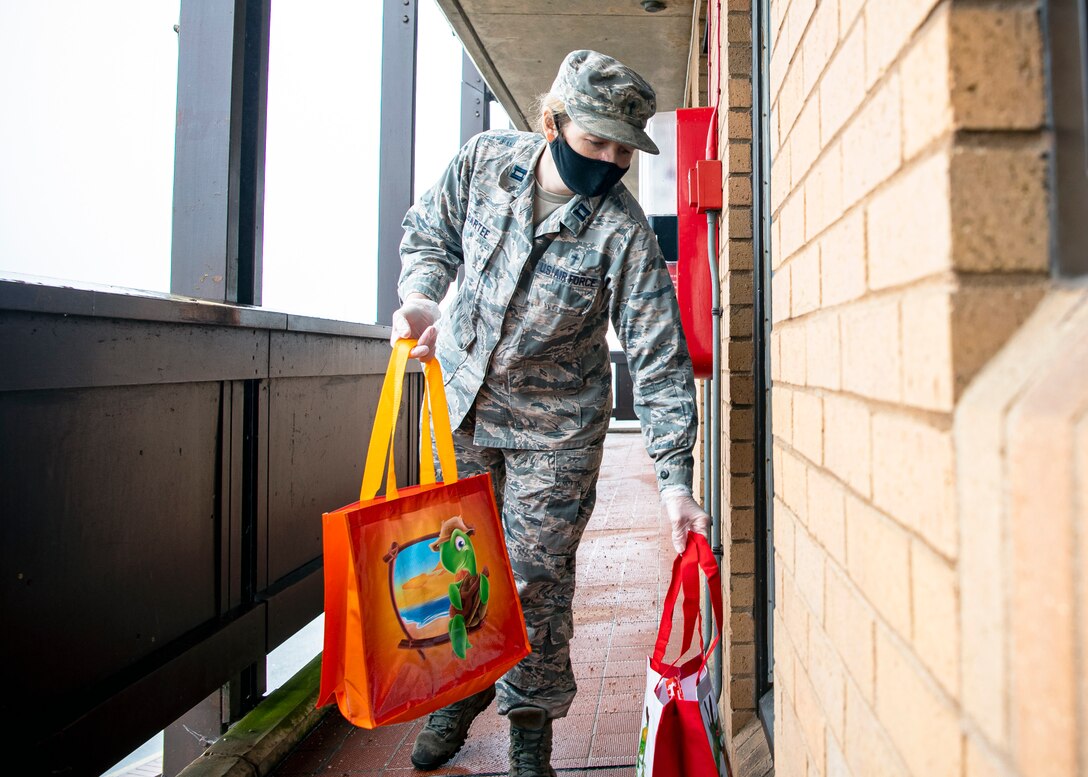 U.S. Air Force Captain Amy Bartee, 501st CSW chaplain, delivers a care package at RAF Alconbury, Dec. 7, 2020. The RAF Alconbury chaplain team have been providing care packages for Airmen and families currently in quarantine.(U.S. Air Force photo by Senior Airman Eugene Oliver)
