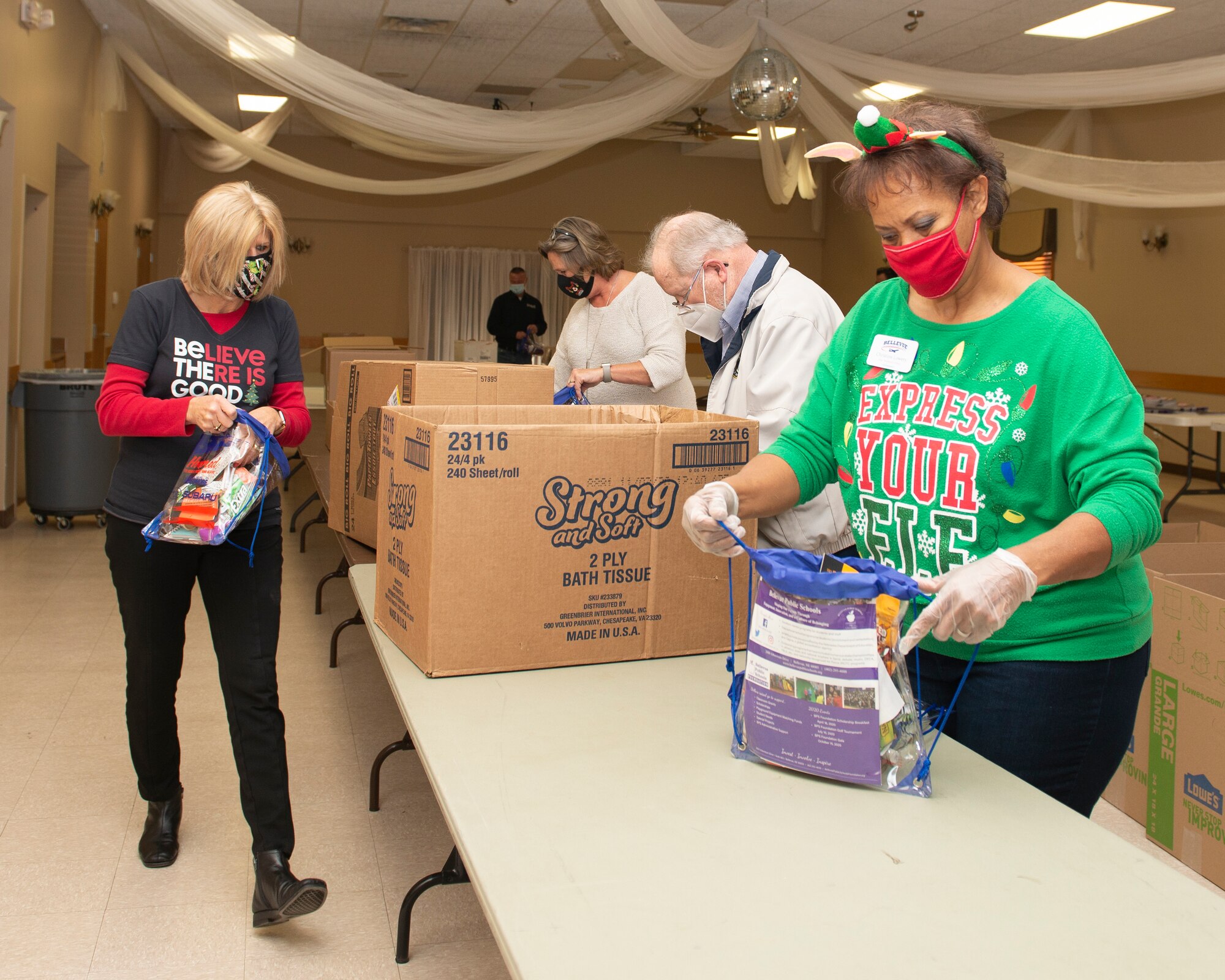 Stand alone photo of Bellevue Chamber filling holiday bags for Offutt dorm residents