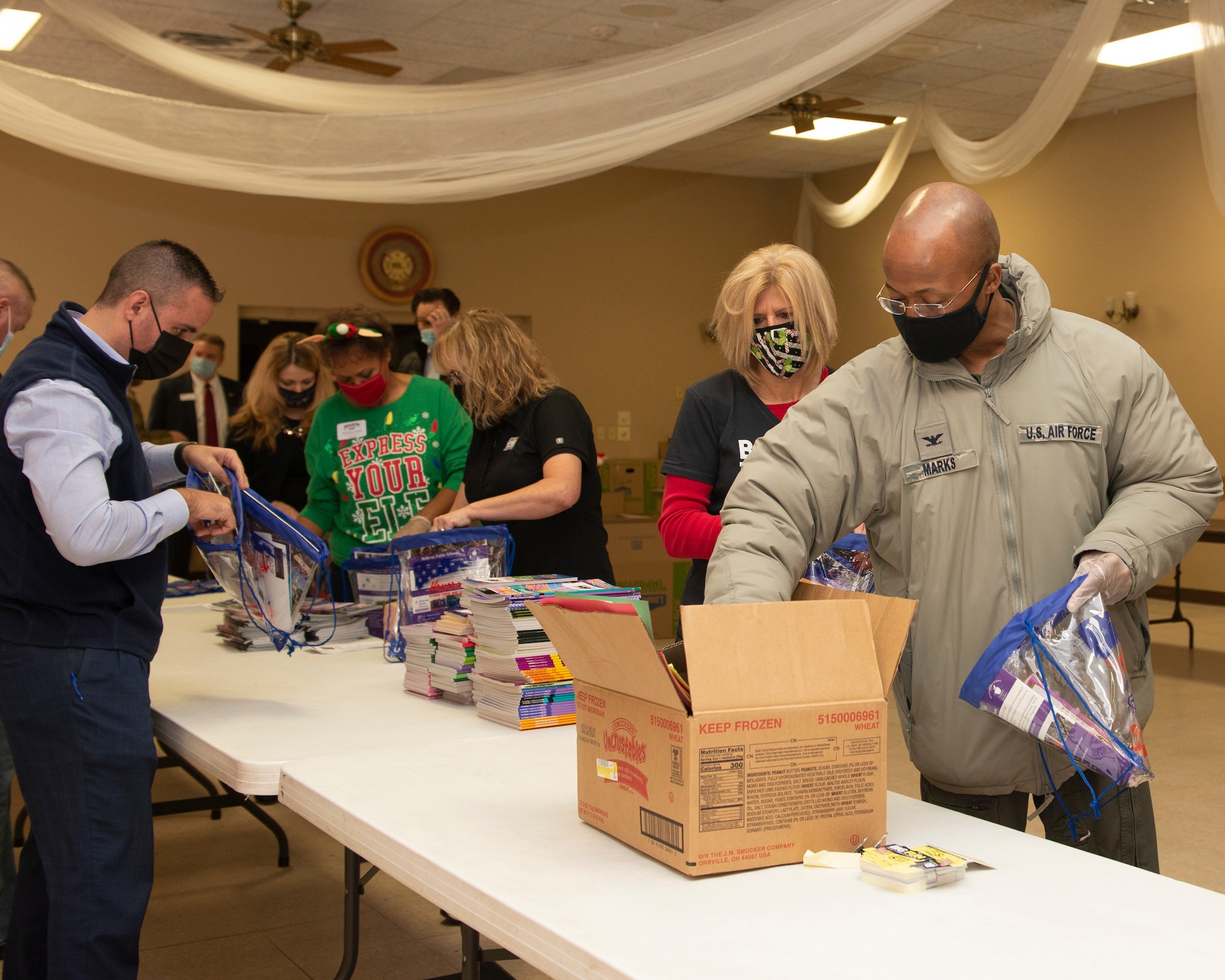 Stand alone photo of Bellevue Chamber filling holiday bags for Offutt dorm residents