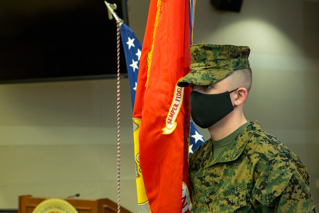 U.S. Marine Corps Cpl. Ryan Donnelly holds the U.S. Marine Corps Forces Northern Command (MARFORNORTH) colors during the transfer of authority ceremony between U.S. Marine Corps Forces Reserve and U.S. Marine Corps Forces Command, Fleet Marine Force Atlantic, at Naval Support Activity Hampton Roads, Norfolk, Virginia, Dec. 8, 2020. The transfer of MARFORNORTH roles and responsibilities will enhance the mission effectiveness of the naval forces assigned to U.S. Northern Command as they conduct their primary mission of Homeland Defense through more fully integrated staff processes, and additional opportunities for integration between Navy and Marine Corps counterparts. (U.S. Marine Corps Photo by Sgt. Danielle Prentice/Released)
