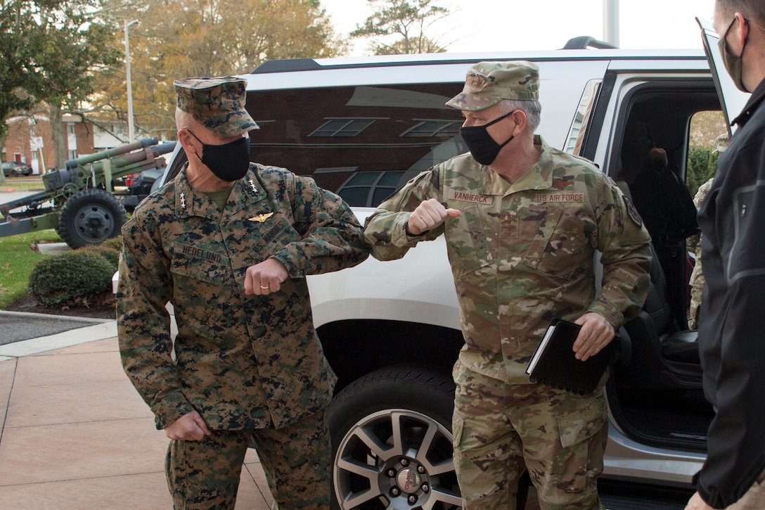 U.S. Marine Corps Lt. Gen. Robert F. Hedelund, Commander, U.S. Marine Corps Forces Command (MARFORCOM), and Commanding General, Fleet Marine Force Atlantic (FMFLANT), left, greets U.S. Air Force Gen. Glen D. VanHerck, Commander, North American Aerospace Defense Command and U.S. Northern Command, before the U.S. Marine Corps Forces Northern Command (MARFORNORTH) transfer of authority ceremony between U.S. Marine Corps Forces Reserve and MARFORCOM, FMFLANT at Naval Support Activity Hampton Roads, Norfolk, Virginia, Dec. 8, 2020. The transfer of MARFORNORTH roles and responsibilities will enhance the mission effectiveness of the naval forces assigned to U.S. Northern Command as they conduct their primary mission of Homeland Defense through more fully integrated staff processes, and additional opportunities for integration between Navy and Marine Corps counterparts.  (U.S. Marine Corps Photo by Sgt. Danielle Prentice/Released)
