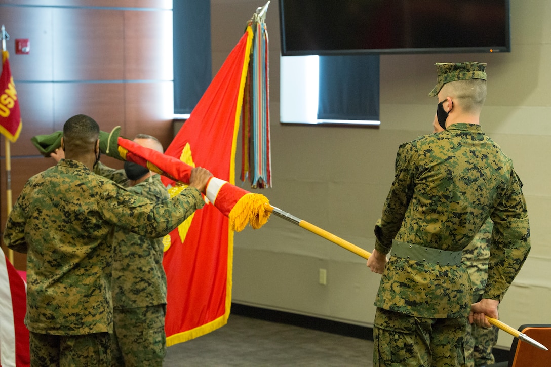 U.S. Marine Corps Lt. Gen. Robert F. Hedelund, Commander, U.S. Marine Corps Forces Command (MARFORCOM), and Commanding General, Fleet Marine Force Atlantic (FMFLANT), and Sgt. Maj. Clifford W. Wiggins, Sergeant Major of MARFORCOM and FMFLANT, and Cpl. Ryan Donnelly, the color bearer, uncase the colors during the U.S. Marine Corps Forces Northern Command (MARFORNORTH) transfer of authority ceremony between U.S. Marine Corps Forces Reserve and MARFORCOM, FMFLANT at Naval Support Activity Hampton Roads, Norfolk, Virginia, Dec. 8, 2020. The transfer of MARFORNORTH roles and responsibilities will enhance the mission effectiveness of the naval forces assigned to U.S. Northern Command as they conduct their primary mission of Homeland Defense through more fully integrated staff processes, and additional opportunities for integration between Navy and Marine Corps counterparts. (U.S. Marine Corps Photo by Sgt. Desmond Martin/Released)