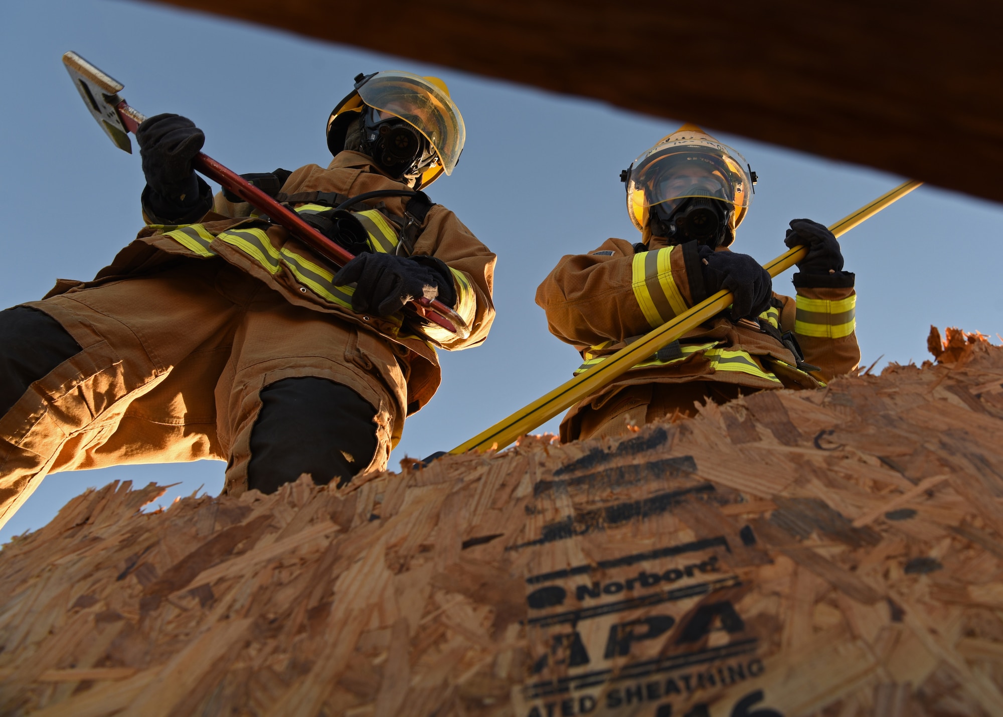U.S. Air National Guard Airman 1st Class Geovannie Rios-Santos and Air Force Airman Nathan Lott, 312th Training Squadron fire protection students, successfully cut out a 4x4 foot section of an artificial roof during their vertical ventilation training at the Louis F. Garland Department of Defense Fire Academy on Goodfellow Air Force Base, Texas, Dec. 10, 2020. With the exhaust port created, firefighters have increased visibility and safety when entering the building at the ground level. (U.S. Air Force photo by Senior Airman Abbey Rieves)