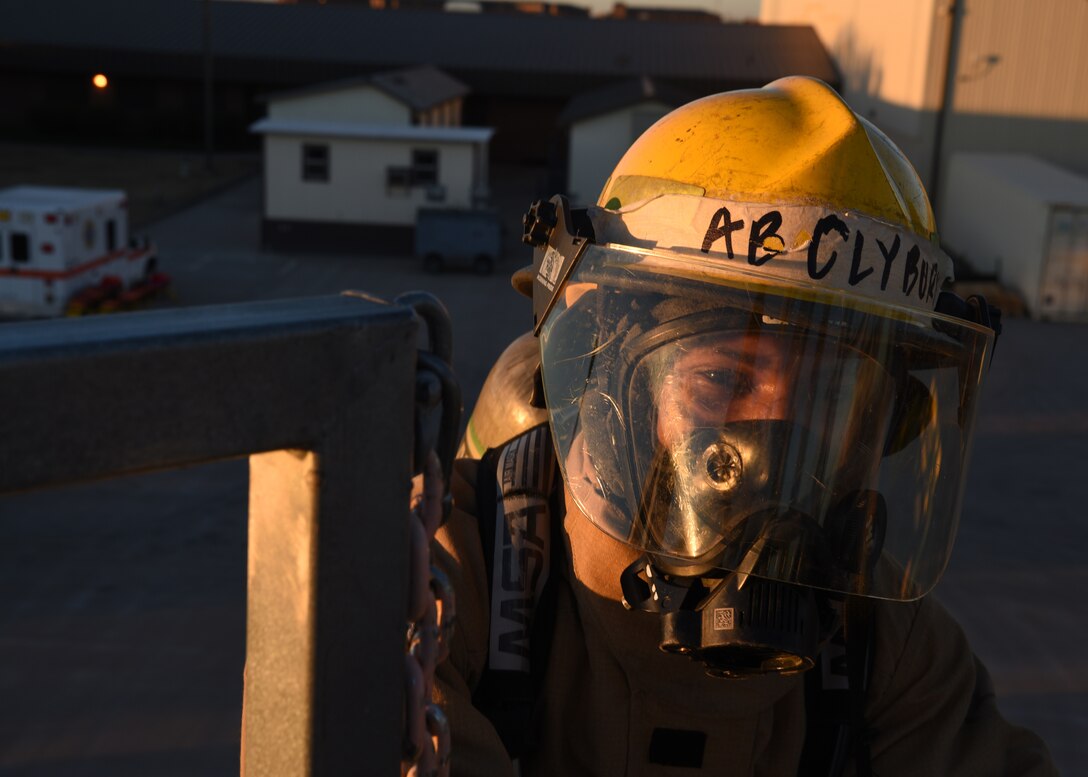 U.S. Air National Guard Airman Toryon Clyburn, 312th Training Squadron fire protection student, arrives at the egress point in order to join his partner on the artificial rooftop in an emergency operations training exercise, at the Louis F. Garland Department of Defense Fire Academy on Goodfellow Air Force Base, Texas, Dec. 10, 2020. Clyburn followed a strict rule of “two in, two out,” which required the buddy system in the fire service whenever operating in an “Immediately Dangerous to Life and Health” atmosphere, such as vertical ventilation training. (U.S. Air Force photo by Senior Airman Abbey Rieves)