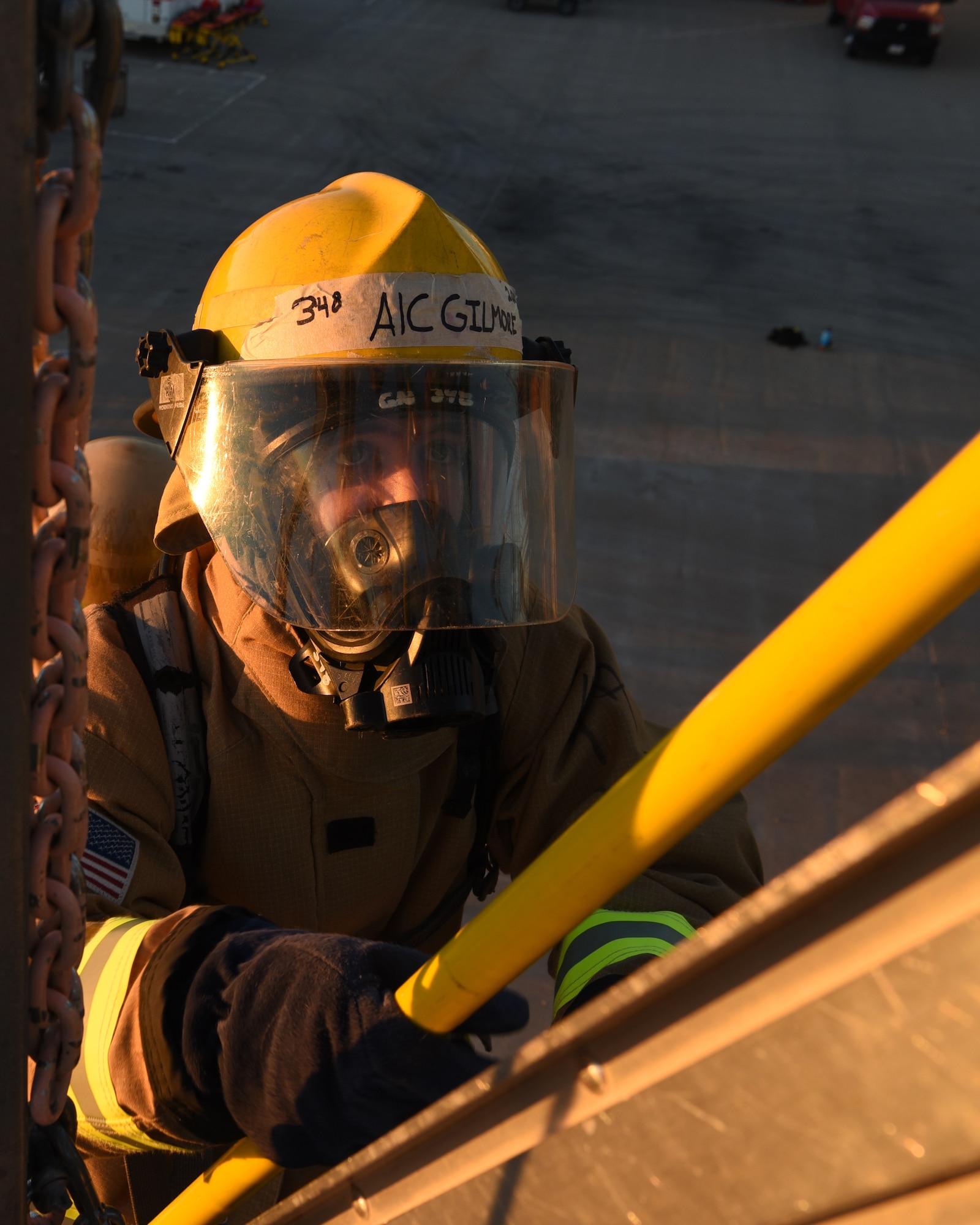 U.S. Air Force Airman 1st Class Trevor Gilmore, 312th Training Squadron fire protection student, transitions from ladder to roof carrying a fire hook for his vertical ventilation practice during a training exercise at the Louis F. Garland Department of Defense Fire Academy on Goodfellow Air Force Base, Texas, Dec. 10, 2020. Gilmore will use the fire hook in the offensive strategy of vertical ventilation, which creates an exhaust port for the harmful gasses to exist the structure. (U.S. Air Force photo by Senior Airman Abbey Rieves)