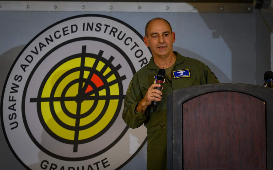 Airman speaks on stage.