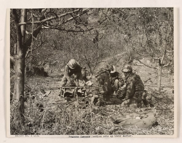 U.S. Marines set up their mortar to take communist positions under fire near Chosin Reservoir.