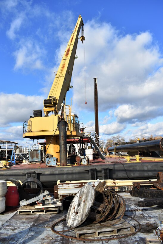 IN THE PHOTO, a crane removes barrels off the Dredge Hurley, which is now docked at Ensley Engineer Yard for some much-needed repairs after another long but successful season of dredging the Mississippi River. Adrian Pirani, Dredge Hurley master, said the crew successfully removed a little more than 8 million cubic yards of sediment this season. The season was shorter than last year due to the Hurley needing maintenance done, which required the Hurley be placed on a larger dry dock down south for a few months earlier this year. (USACE photos by Jessica Haas)