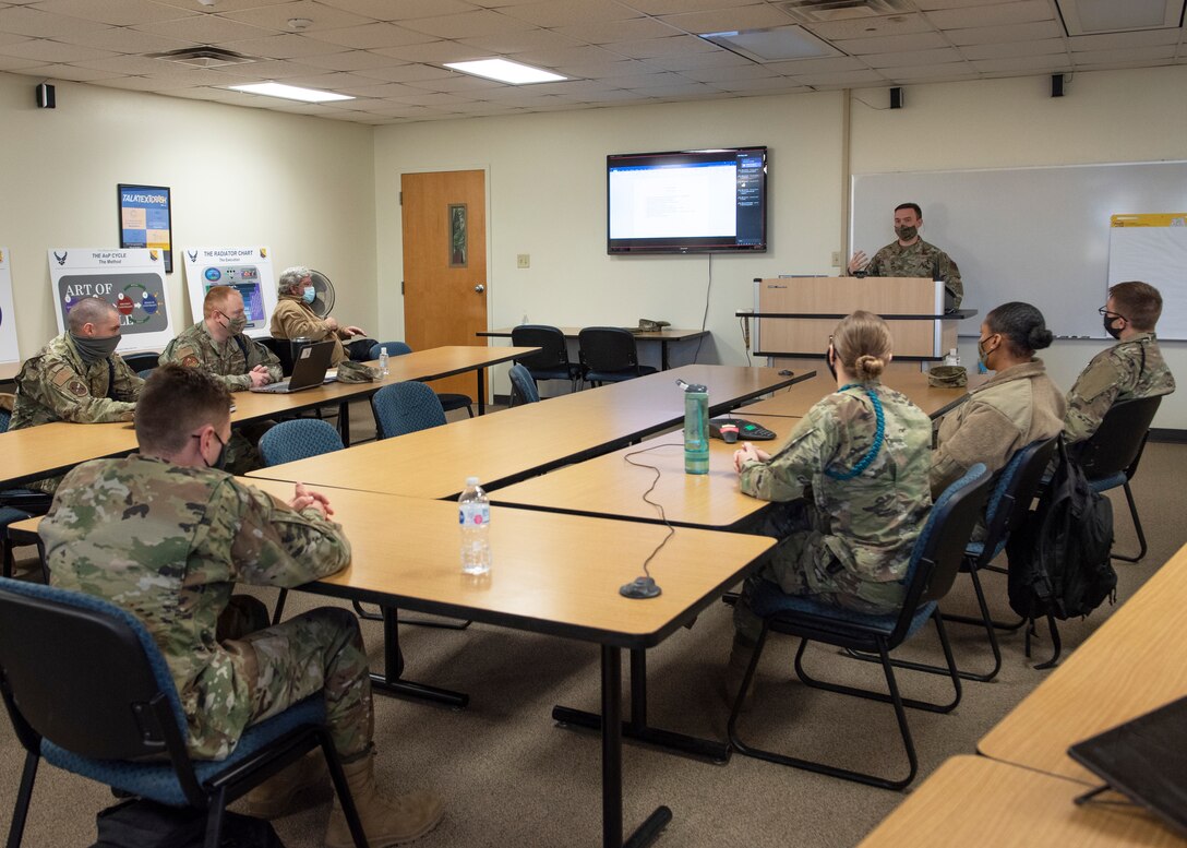 Airmen from various squadrons and backgrounds discuss while at the Art of Process event at Sheppard Air Force Base, Texas, Dec. 9, 2020. The Art of Process event was a three day meeting between multiple agencies, squadrons, facilities as well as their counterparts on other Air Force Bases. The main focus was on improving the process of getting Airmen in Training to their assignment. This includes getting orders and assignments quicker, getting the Airmen ready sooner for their future assignments (i.e. updated medically, firearm qualifications, briefed, etc.) and other processes that could be streamlined or replaced with innovative ideas. (U.S. Air Force photo by Senior Airman Pedro Tenorio)