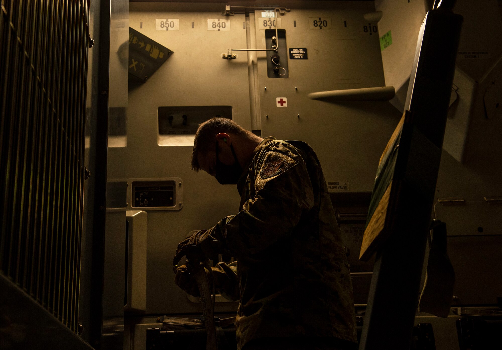 Master Sgt. Gregory Roush, 7th Logistics Readiness Squadron incoming air transportation function section chief, puts together cargo straps inside a C-17 Globemaster III at Dyess Air Force Base, Texas, Nov. 25, 2020.