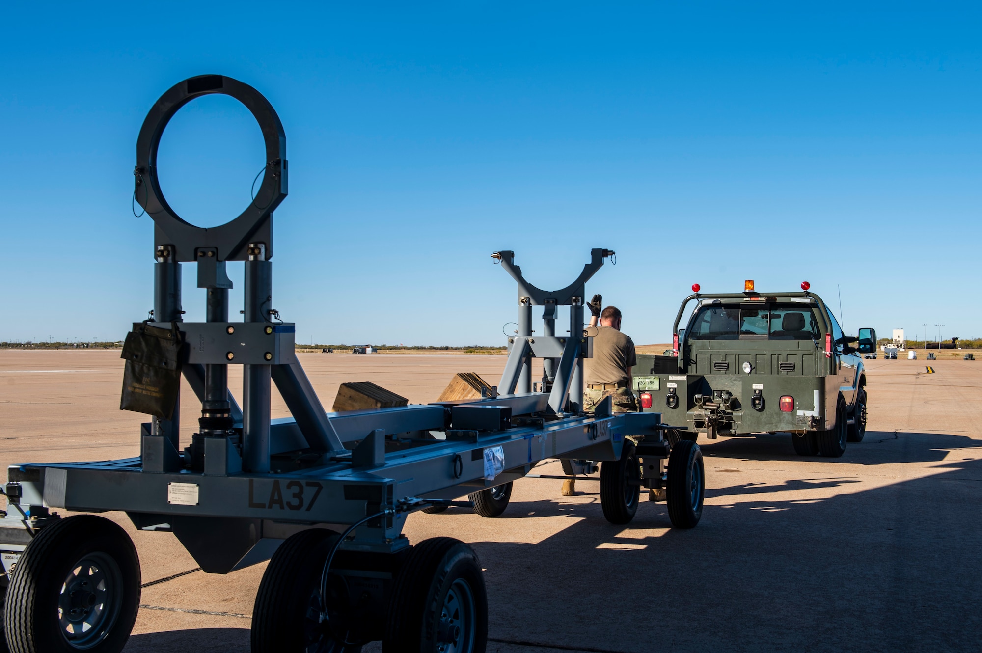 Staff Sgt. Gideon-Levi Simmons, 7th Logistics Readiness Squadron air transportation function air transportation function noncommissioned officer in charge of programs, guides a truck to tow cargo at Dyess Air Force Base, Texas, Nov. 25, 2020.