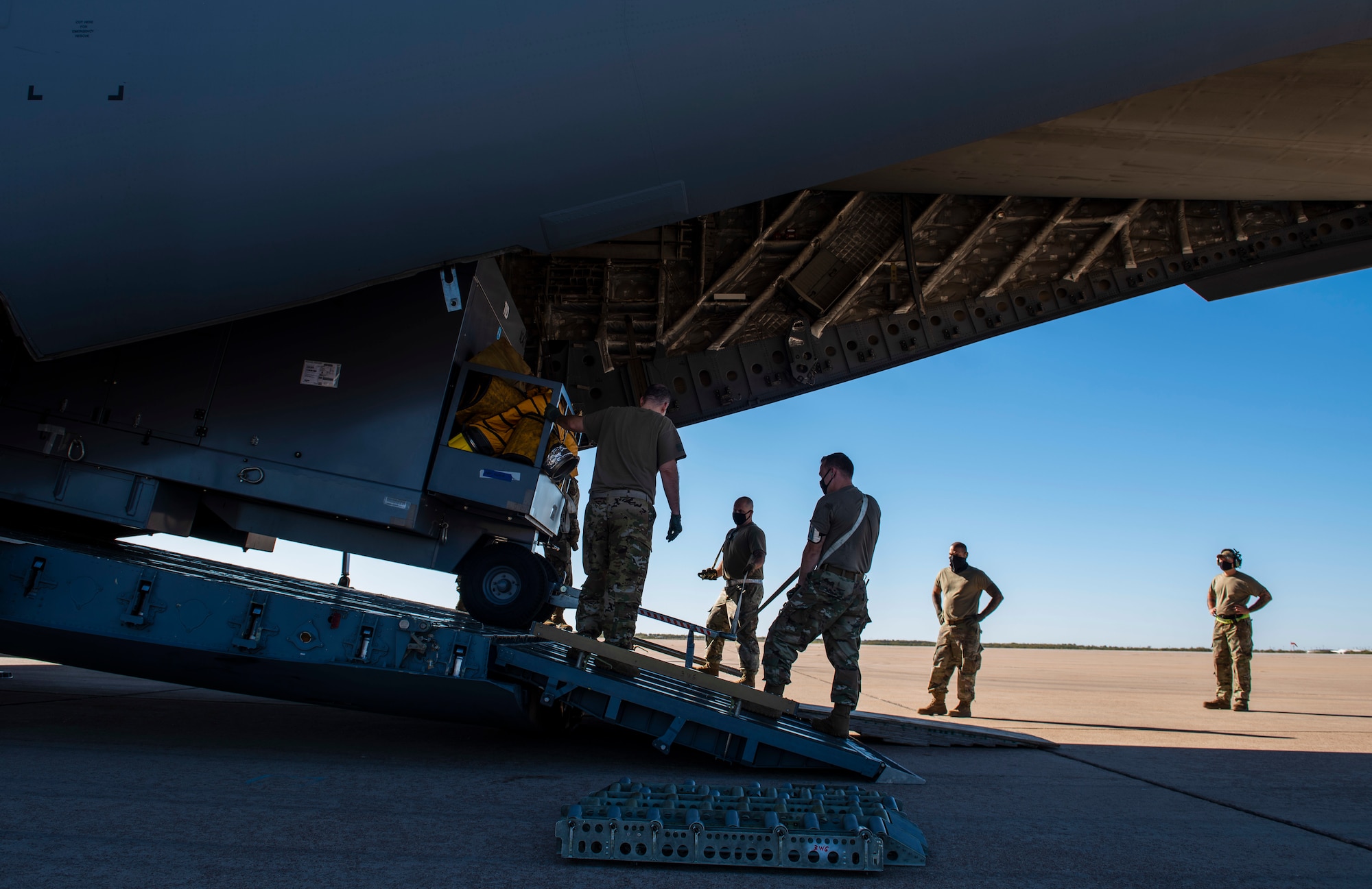 Airmen assigned to the 7th Logistics Readiness Squadron air transportation function unload cargo from a C-17 Globemaster III at Dyess Air Force Base, Texas, Nov. 25, 2020.
