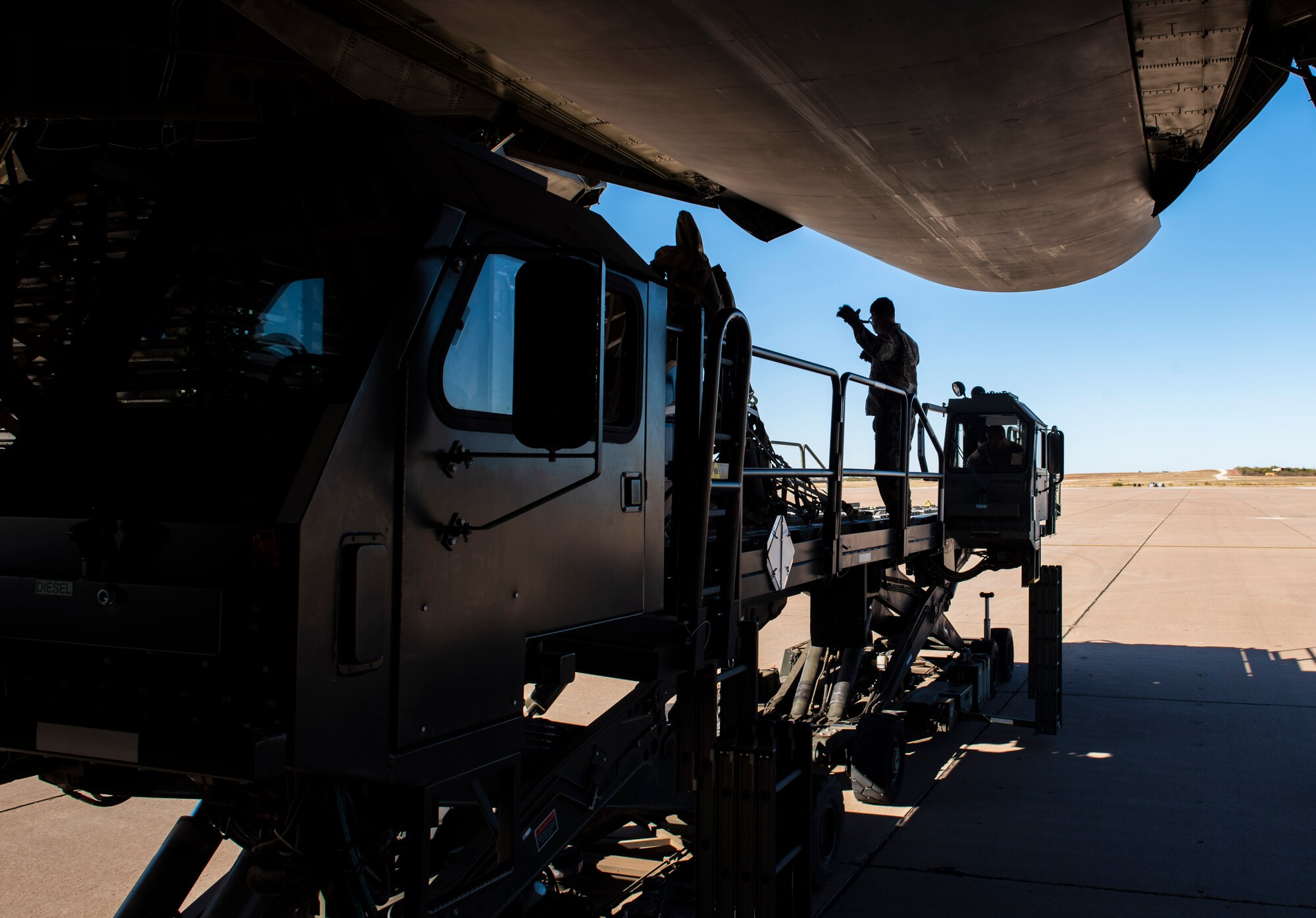 Staff Sgt. Zachary Parsons, 7th Logistics Readiness Squadron air transportation function noncommissioned officer in charge of training, guides cargo being unloaded from a C-5M Super Galaxy at Dyess Air Force Base, Texas, Nov. 25, 2020.
