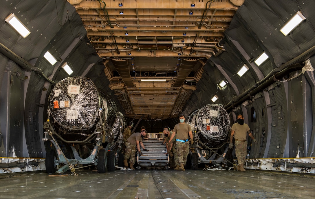 Airmen assigned to the 7th Logistics Readiness Squadron air transportation function prepare to unload cargo at Dyess Air Force Base, Texas, Nov. 25, 2020.