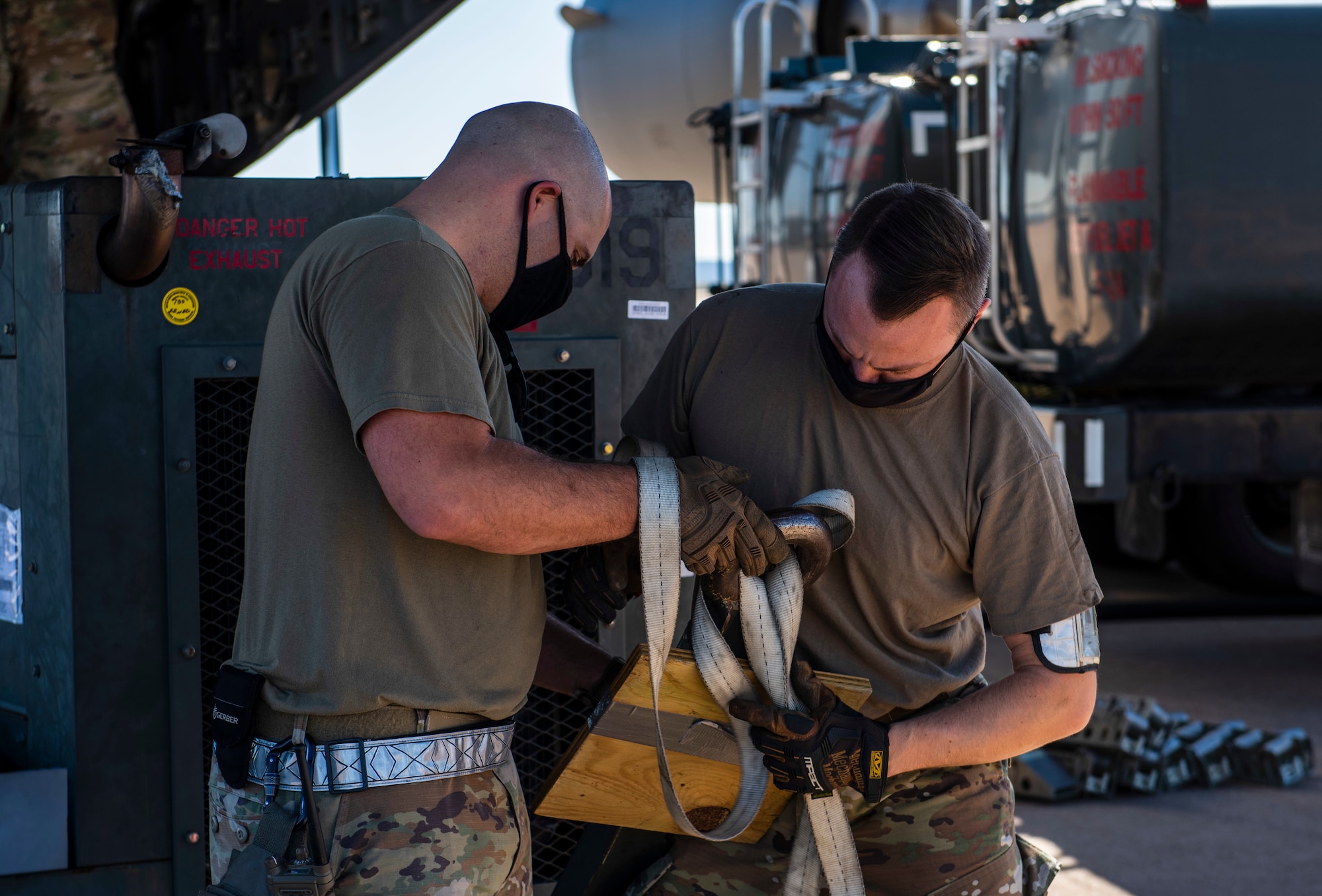 Tech. Sgt. Anthony Como, 7th Logistics Readiness Squadron air transportation function noncommissioned officer in charge of load planning, left, and Staff Sgt. Gideon-Levi Simmons, 7th LRS air transportation function air transportation function NCO in charge of programs, unravel cargo straps at Dyess Air Force Base, Texas, Nov. 25, 2020.