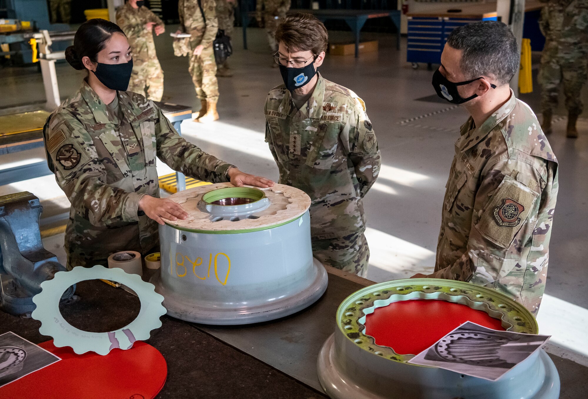 Airman 1st Class Sheila Tilden, 436th Maintenance Squadron aircraft structural maintenance journeyman, puts on a demonstration for Gen. Jacqueline Van Ovost, Air Mobility Command commander, and Chief Master Sgt. Brian Kruzelnick, AMC command chief, during their visit to Dover Air Force Base, Delaware, Dec. 8, 2020. Van Ovost and Kruzelnick experienced firsthand how Team Dover Airmen support Total Force Mobility.  (U.S. Air Force photo by Senior Airman Christopher Quail)