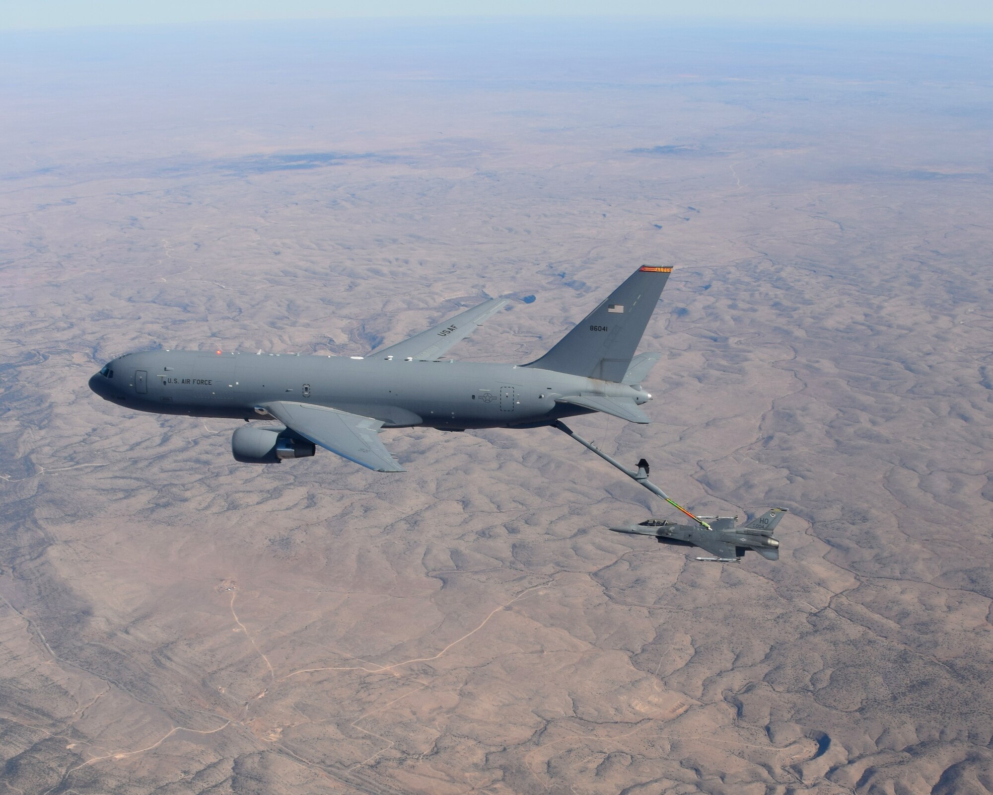 A KC-46 Pegasus from the 56th Air Refueling Squadron at Altus Air Force Base (AFB), Oklahoma, refuels an F-16 Fighting Falcon from the 49th Wing at Holloman AFB, New Mexico, December 7, 2020. Two Altus AFB KC-46s and ten Holloman AFB F-16s teamed up in the skies over New Mexico to practice air refueling operations. (Courtesy photo by 1st Lt. Daniel Lee)