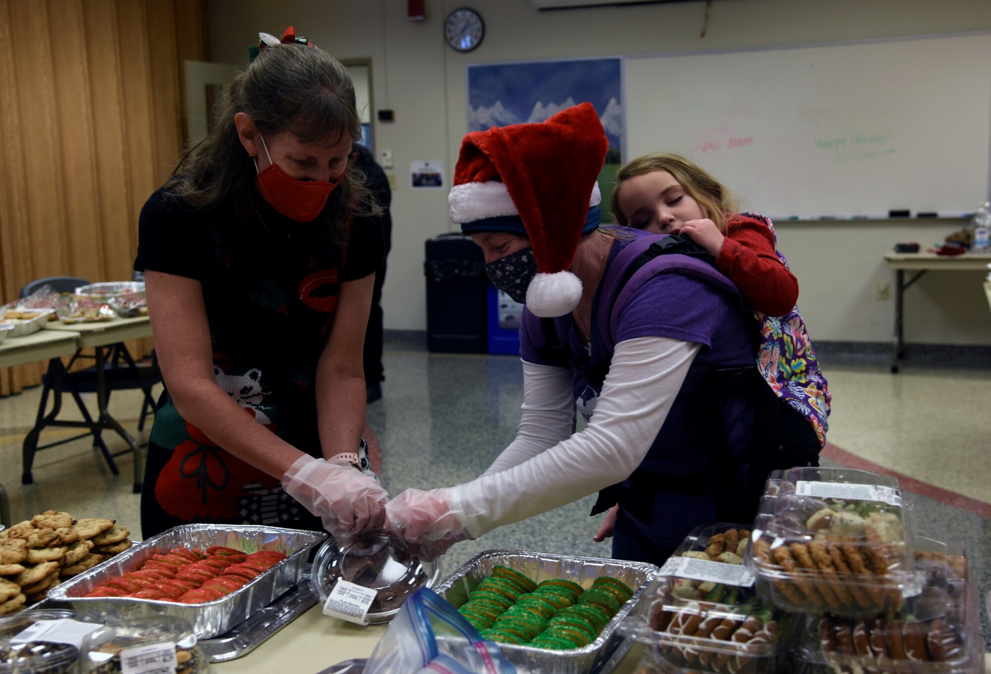 Two people preparing boxes of cookies