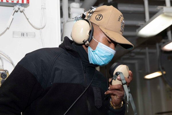 Boatswain's Mate Seaman Deandre Hampton confirms working communications using a sound-powered phone aboard the Wasp-class amphibious assault ship USS Kearsarge (LHD 3) Dec. 10, 2020.