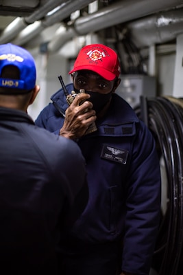 Aviation Support Equipment Technician 1st Class Romeo Martin, assigned to the Wasp-class amphibious assault ship USS Kearsarge (LHD 3), prepares for a flooding drill Dec. 10, 2020.