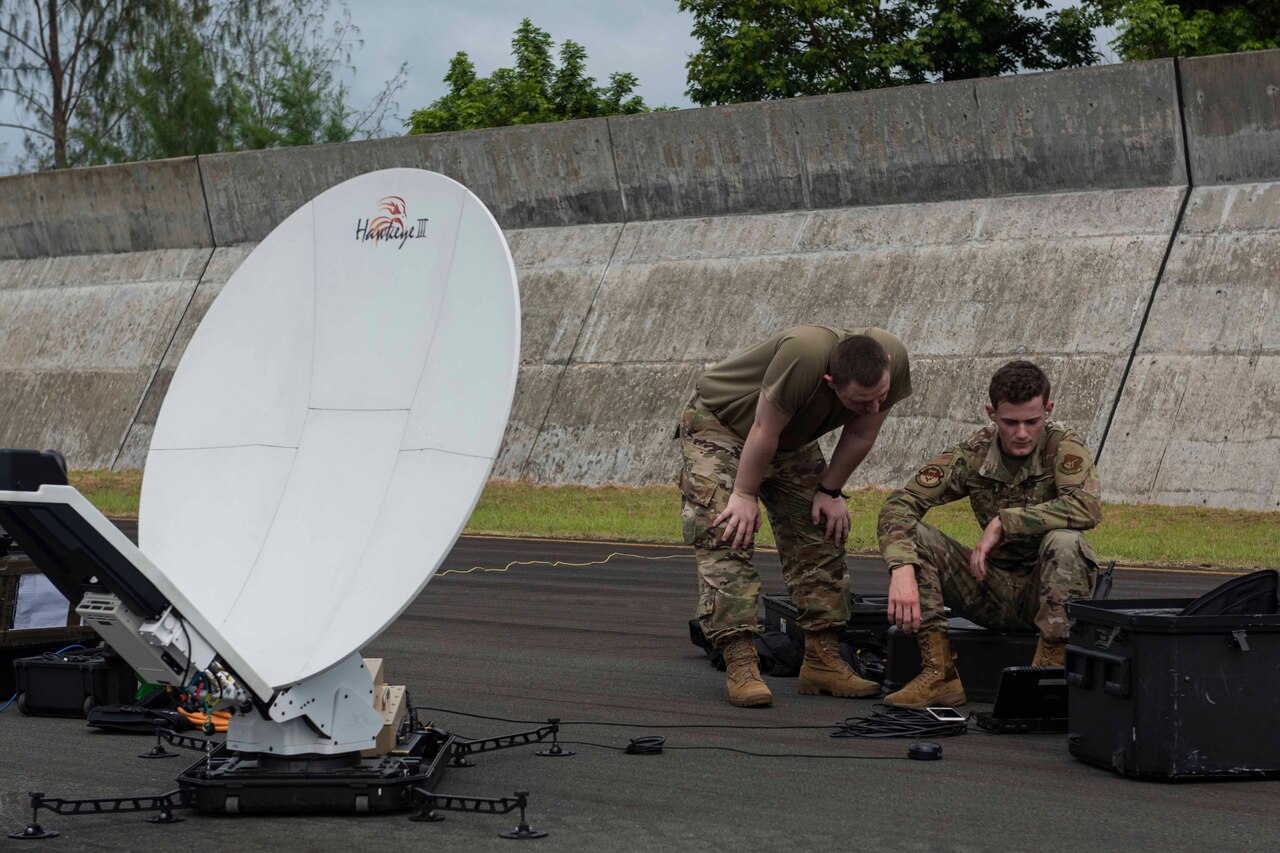 Airmen set up satellite gear.