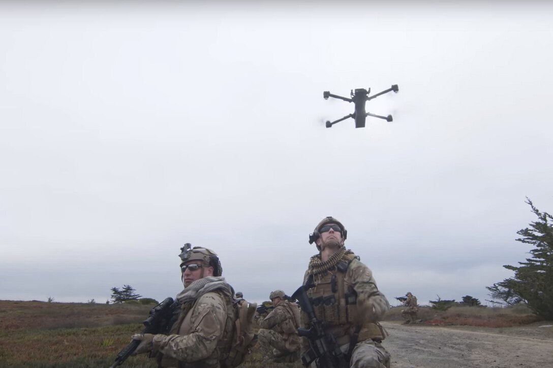 Drone flies above troops.
