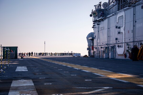 Sailors assigned to the Wasp-class amphibious assault ship USS Kearsarge (LHD 3) search for foreign object debris on the flight deck Dec. 10, 2020.