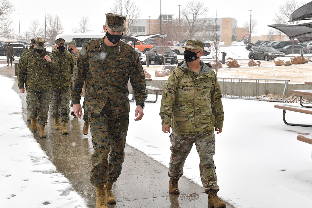 Air Force Maj. Gen. William Holt II (right), U.S. Space Command director of operations and training, escorts Gen. Gary Thomas, assistant commandant of the U.S. Marine Corps, to a space threat briefing Dec. 11, 2020, at Schriever Air Force Base, Colorado. Respective organization leaders also briefed the National Space Defense Center and 527th Space Aggressors Squadron missions during the general’s visit to the installation.