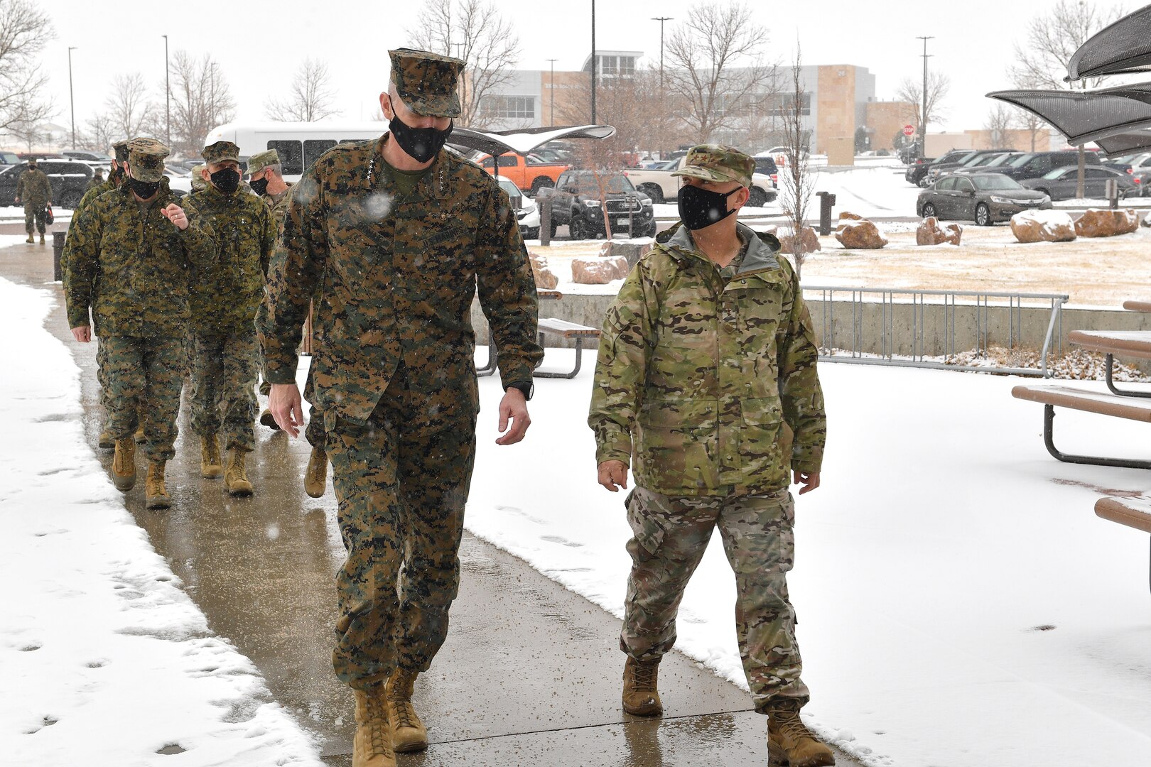 Air Force Maj. Gen. William Holt II (right), U.S. Space Command director of operations and training, escorts Gen. Gary Thomas, assistant commandant of the U.S. Marine Corps, to a space threat briefing Dec. 11, 2020, at Schriever Air Force Base, Colorado. Respective organization leaders also briefed the National Space Defense Center and 527th Space Aggressors Squadron missions during the general’s visit to the installation.