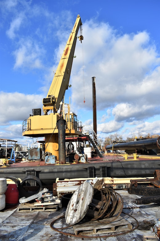 IN THE PHOTO, a crane removes barrels off the Dredge Hurley, which is now docked at Ensley Engineer Yard for some much-needed repairs after another long but successful season of dredging the Mississippi River. Adrian Pirani, Dredge Hurley master, said the crew successfully removed a little more than 8 million cubic yards of sediment this season. The season was shorter than last year due to the Hurley needing maintenance done, which required the Hurley be placed on a larger dry dock down south for a few months earlier this year. (USACE photos by Jessica Haas)