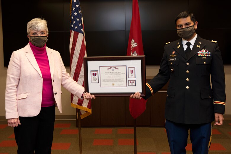 Lt. Col. Sonny B. Avichal, Nashville District commander, presents Patty Coffey, deputy district engineer, with the Department of the Army Superior Civilian Service Medal during a retirement ceremony Dec. 10, 2020 in Nashville, Tennessee, on behalf of Maj. Gen. Robert F. Whittle Jr., Great Lakes and Ohio River Division commanding general, for more than 40 years of outstanding and faithful service to the nation. (USACE Photo by Lee Roberts)