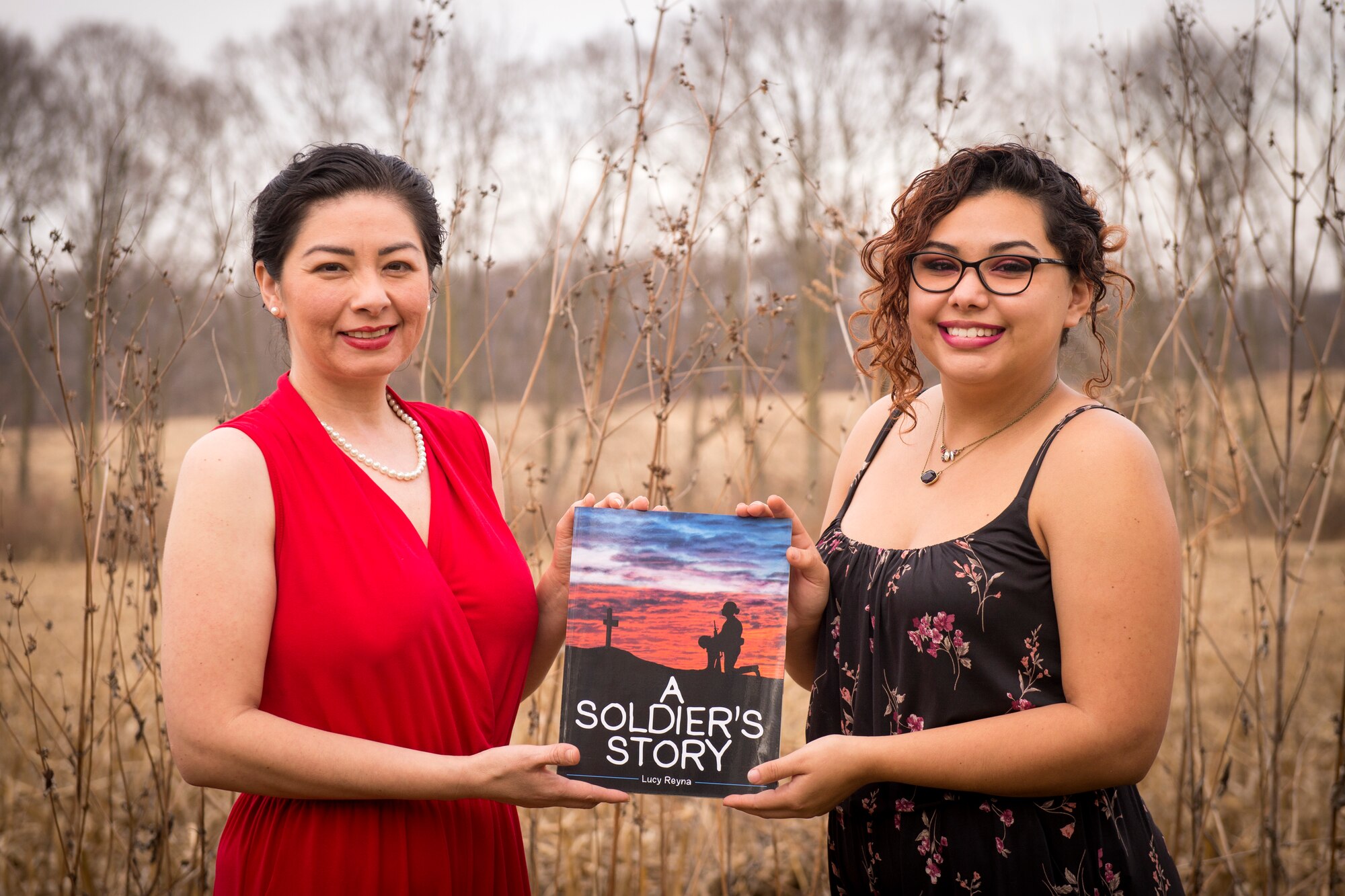 Tech. Sgt. Lucille Reyna, 434th Air Refueling Wing paralegal, and her daughter Sienna Urbina, right, pose for a photo with their children’s book ‘A Soldier’s story’ at their residence in Logansport, Indiana, Dec. 11, 2020. The 28-page book highlights what a service member may experience while on a deployment in a child-friendly way. (U.S. Air Force photo/Master Sgt. Ben Mota)