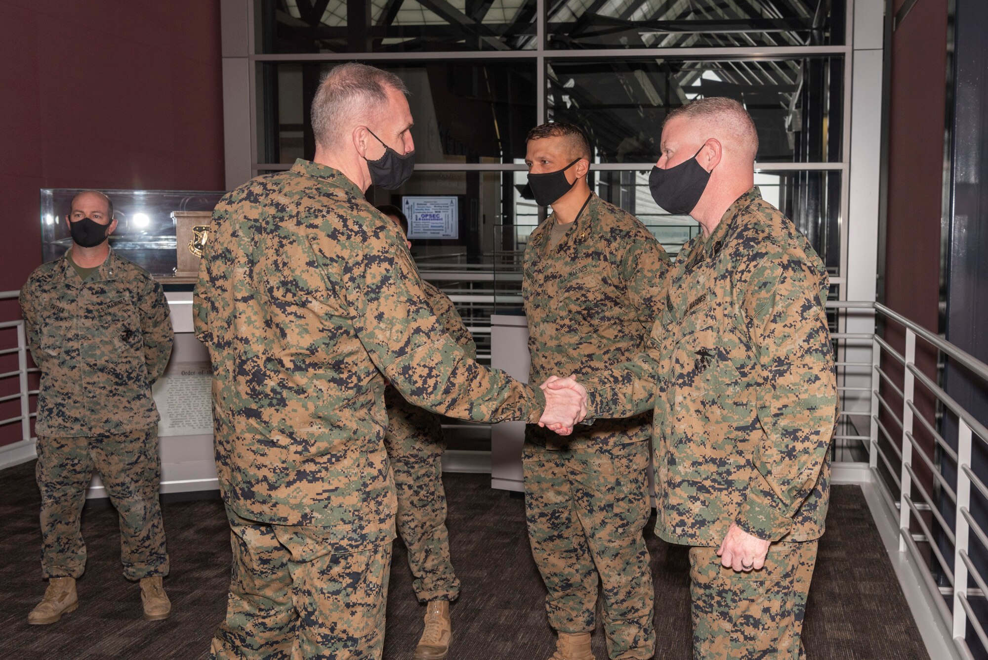 U.S. Marine Corps Master Gunnery Sgt. Scott Stalker (right), U.S. Space Command command senior enlisted leader, greets Gen. Gary Thomas, assistant commandant of the Marine Corps on Dec. 11, 2020, at USSPACECOM headquarters at Peterson Air Force Base, Colorado.