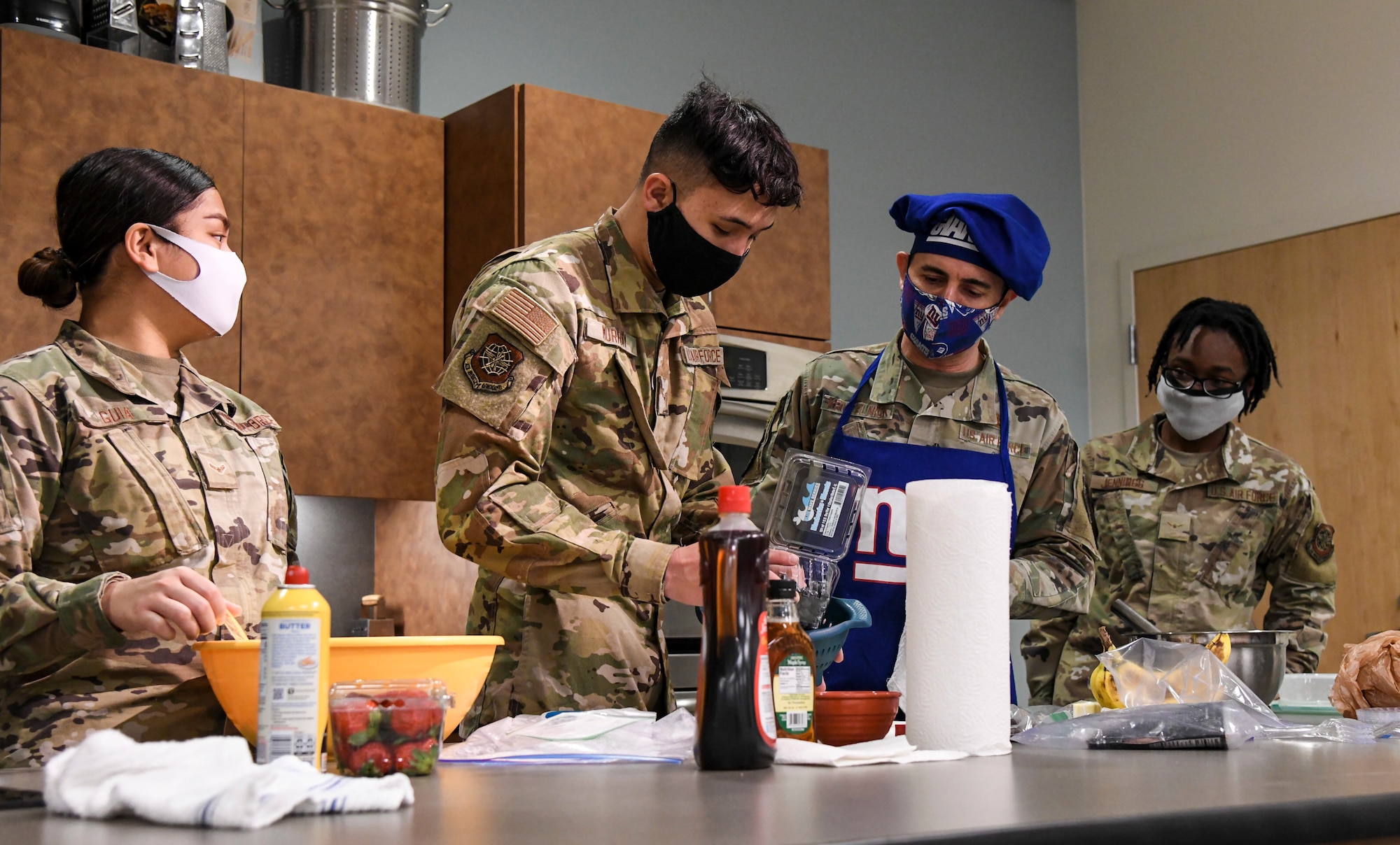 Chief Master Sgt. Brian Kruzelnick, Air Mobility Command command chief, teaches Airmen cooking skills during his visit to Dover Air Force Base, Delaware, Dec. 9, 2020. Dover AFB hosts Dorm to Gourm classes designed to teach Airmen cooking techniques while living in the dorms. (U.S. Air Force photo by Airman 1st Class Stephani Barge)